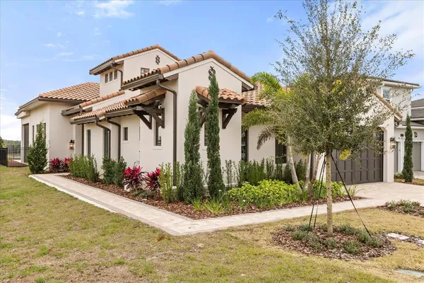 a front view of a house with a yard garage and outdoor seating
