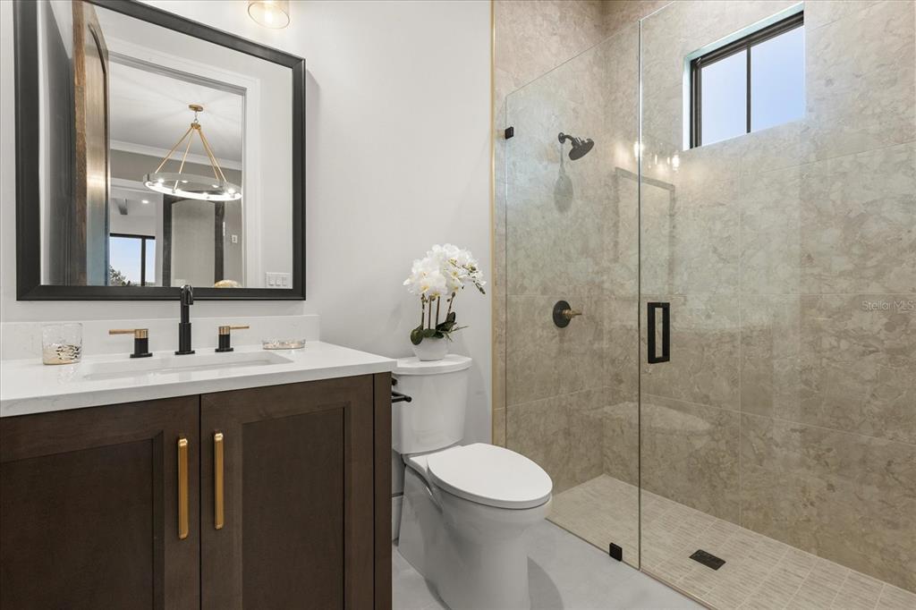 16001 Volterra Point Bella Collina, FL 34756 - Photo 21 of 47 a bathroom with a shower a sink a toilet and mirror