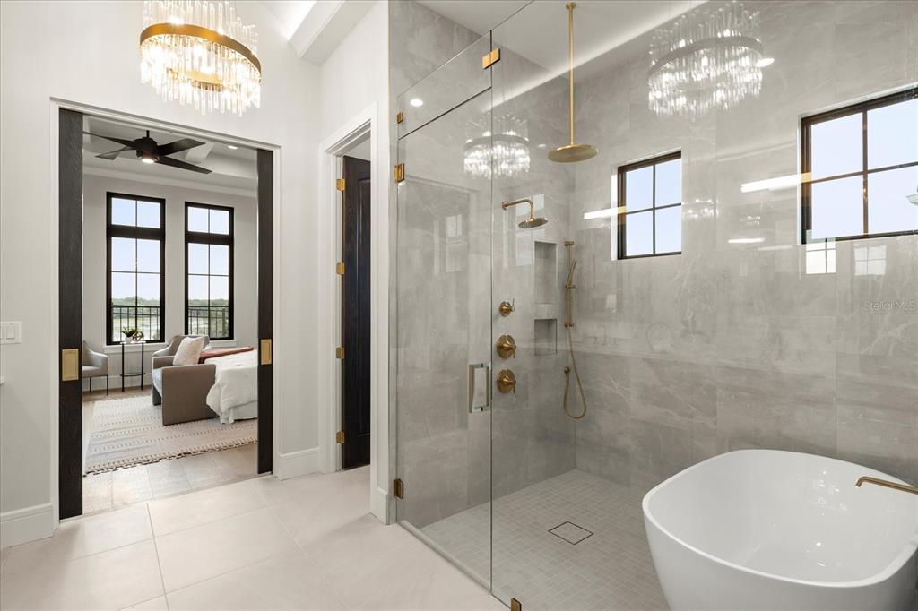 16001 Volterra Point Bella Collina, FL 34756 - Photo 27 of 47 a bathroom with a tub shower and mirror