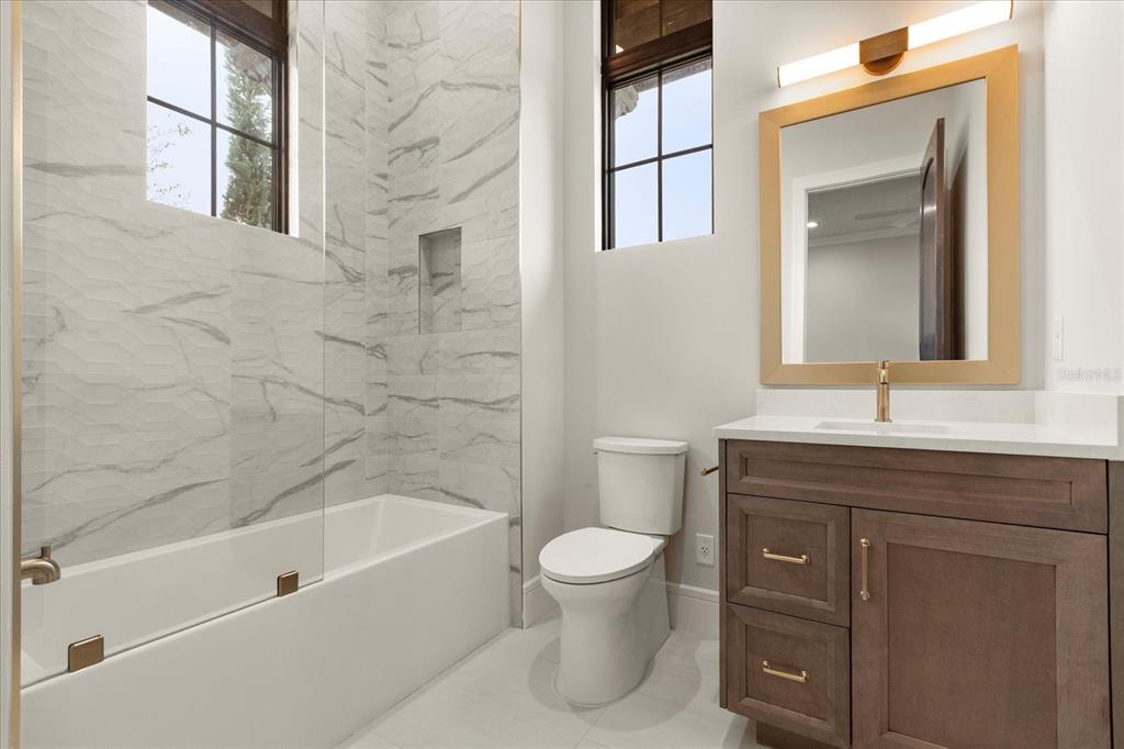 16001 Volterra Point Bella Collina, FL 34756 - Photo 36 of 47 a bathroom with a bathtub sink vanity mirror and toilet