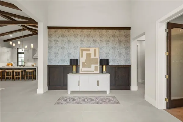 a large white room with a large window and a flat tv screen