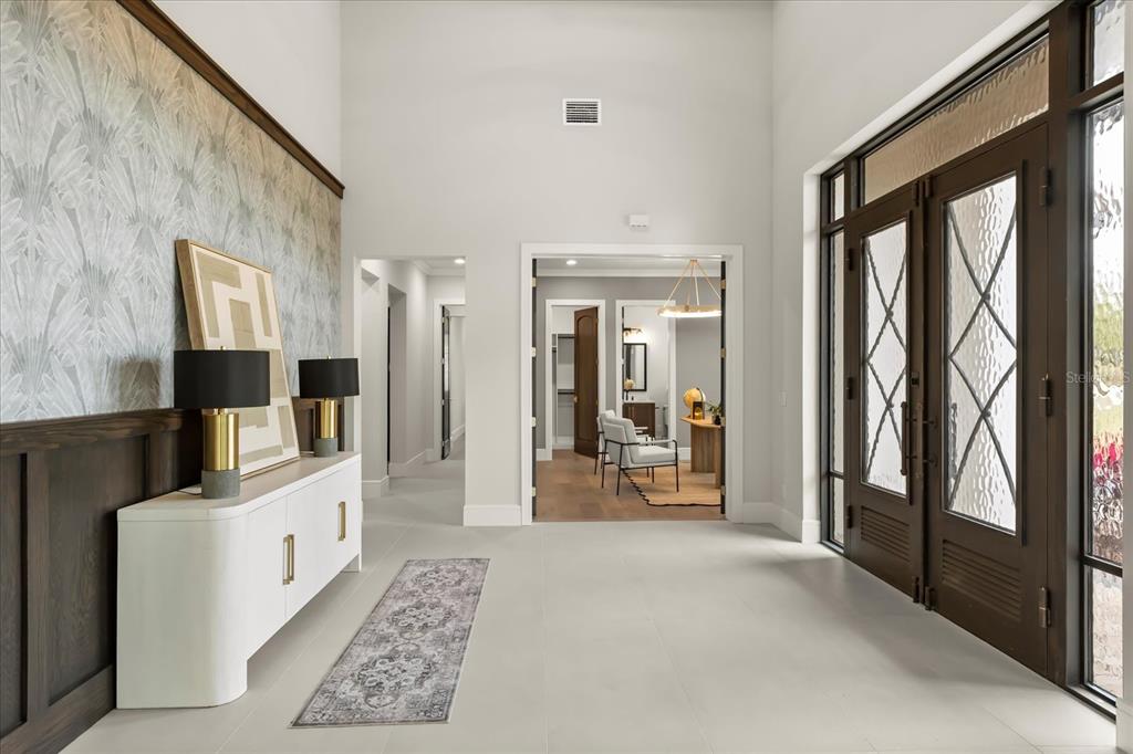 16001 Volterra Point Bella Collina, FL 34756 - Photo 7 of 47 a large white room with a large window and a flat tv screen