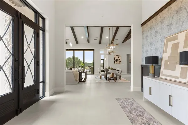 a living room with furniture a flat screen tv and kitchen view