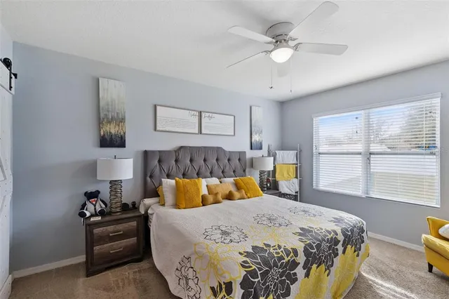 a bedroom with a large bed and a window