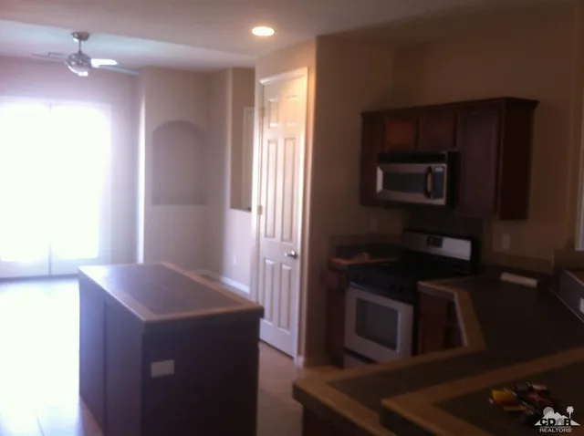 a kitchen that has a sink and a stove top oven