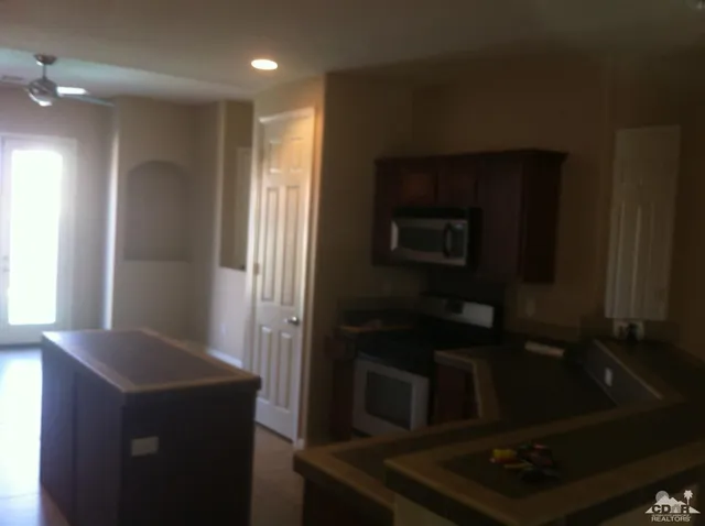 a kitchen with granite countertop cabinets and steel appliances