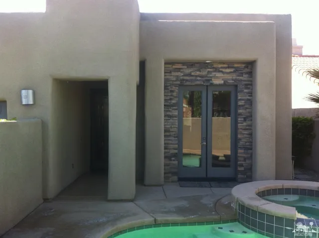 a view of a golf club with a backyard of the house