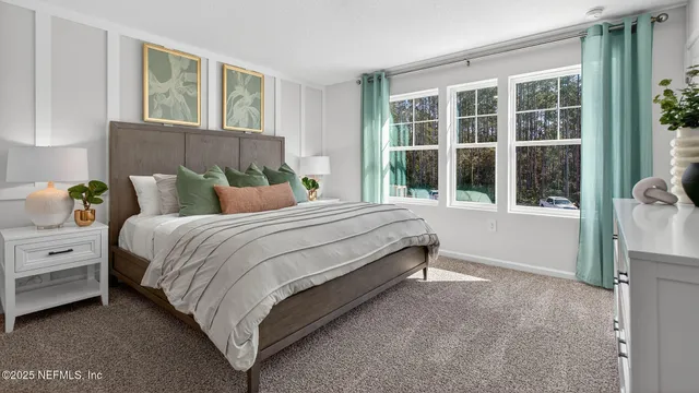 a bedroom with a bed and a large window