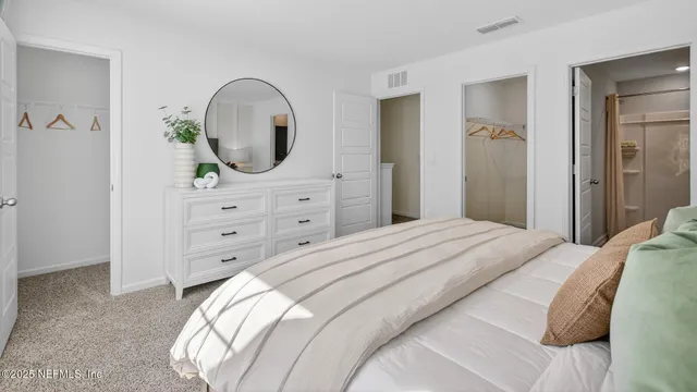 a bedroom with a bed and a dresser