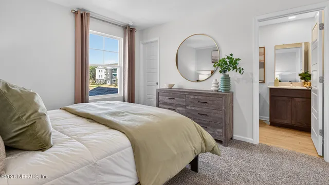 a spacious bedroom with a bed and a dresser