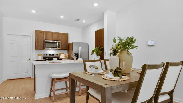 a view of a dining room with furniture and a potted plant