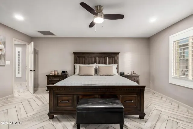 a bedroom with a bed and a window