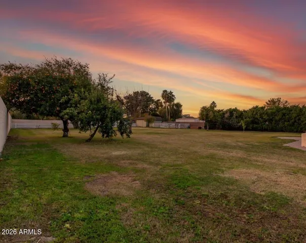 a view of outdoor space with green field and trees
