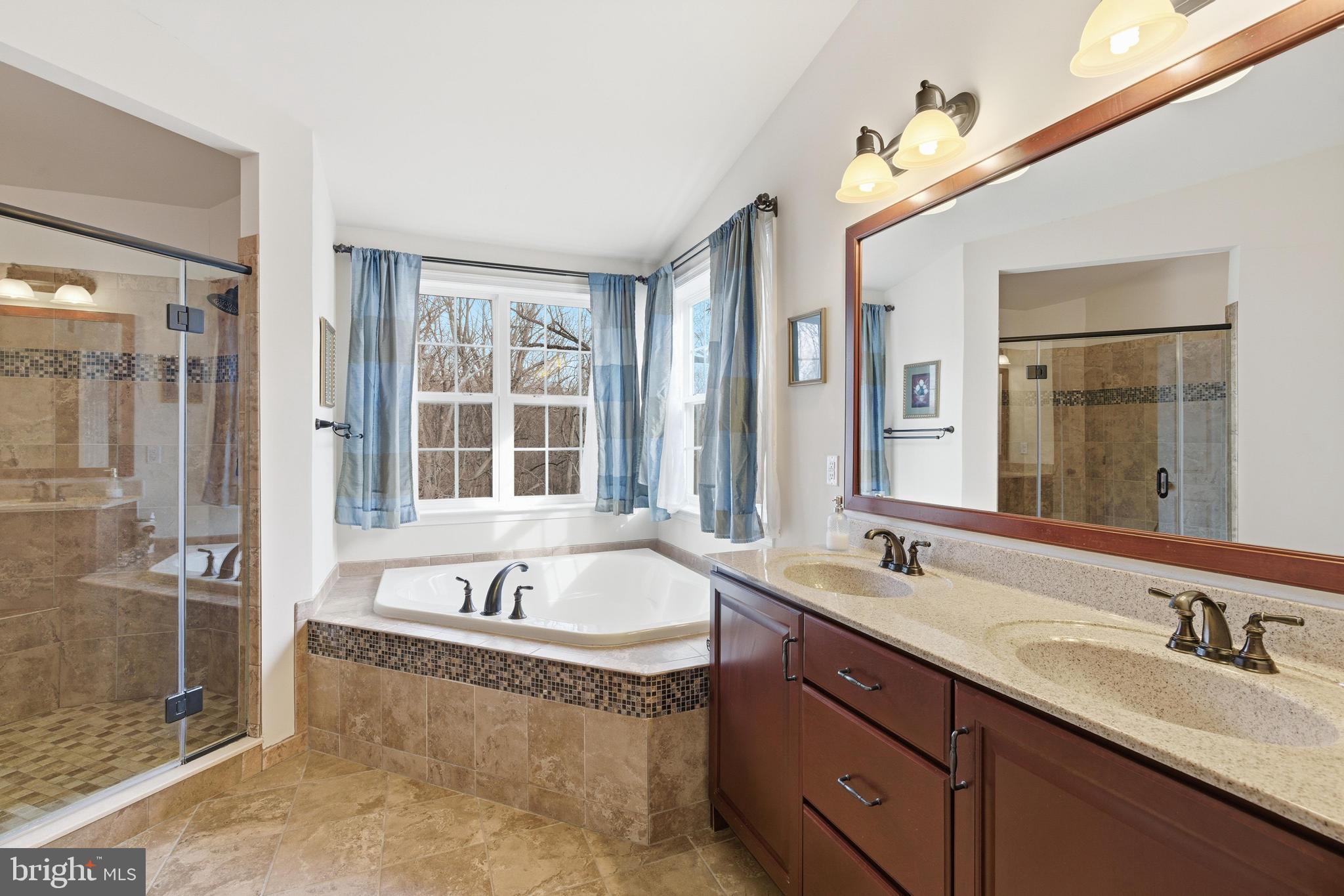 309 Corvus Circle Springfield, PA 19064 - Photo 17 of 34 a spacious bathroom with a tub sink shower and mirror