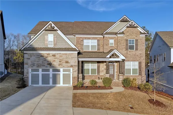 a front view of a house with a yard