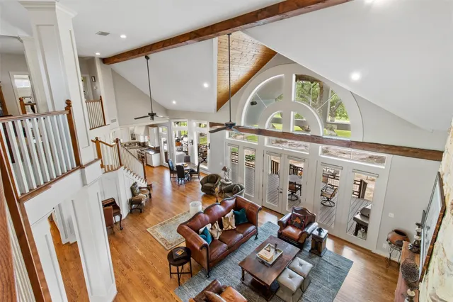 a living room with furniture a floor to ceiling window and a fireplace