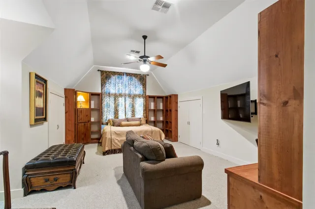 a view of a garden with a house in the background