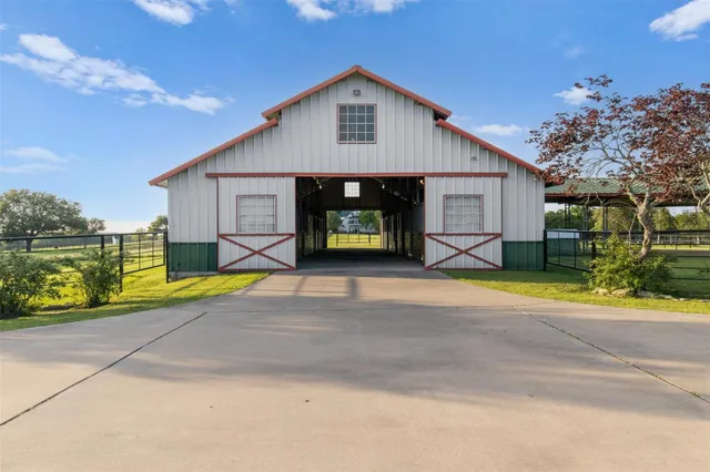 a living room with lots of wooden furniture and a large window