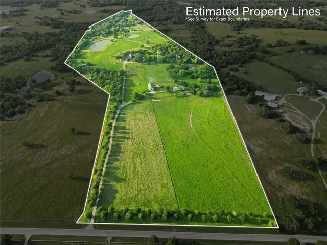 an aerial view of a house with a yard lake lake and outdoor seating