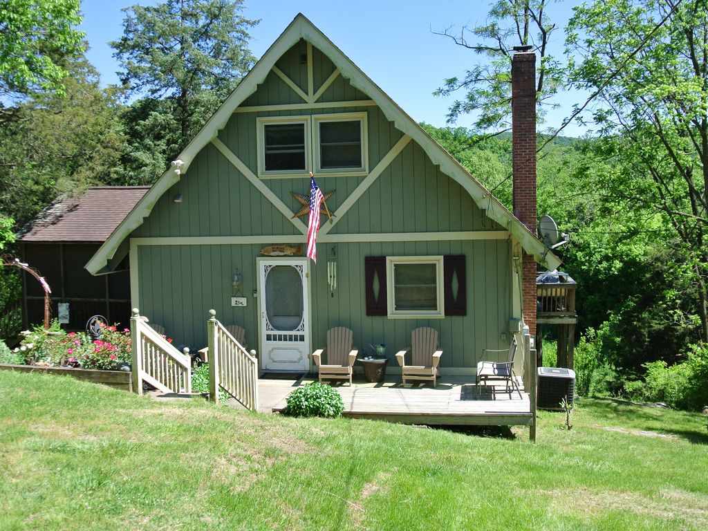 a front view of a house with a yard table and chairs