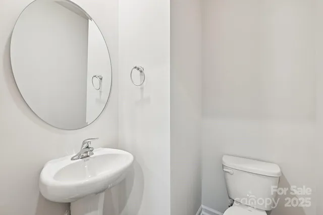a bathroom with a sink a mirror and a toilet