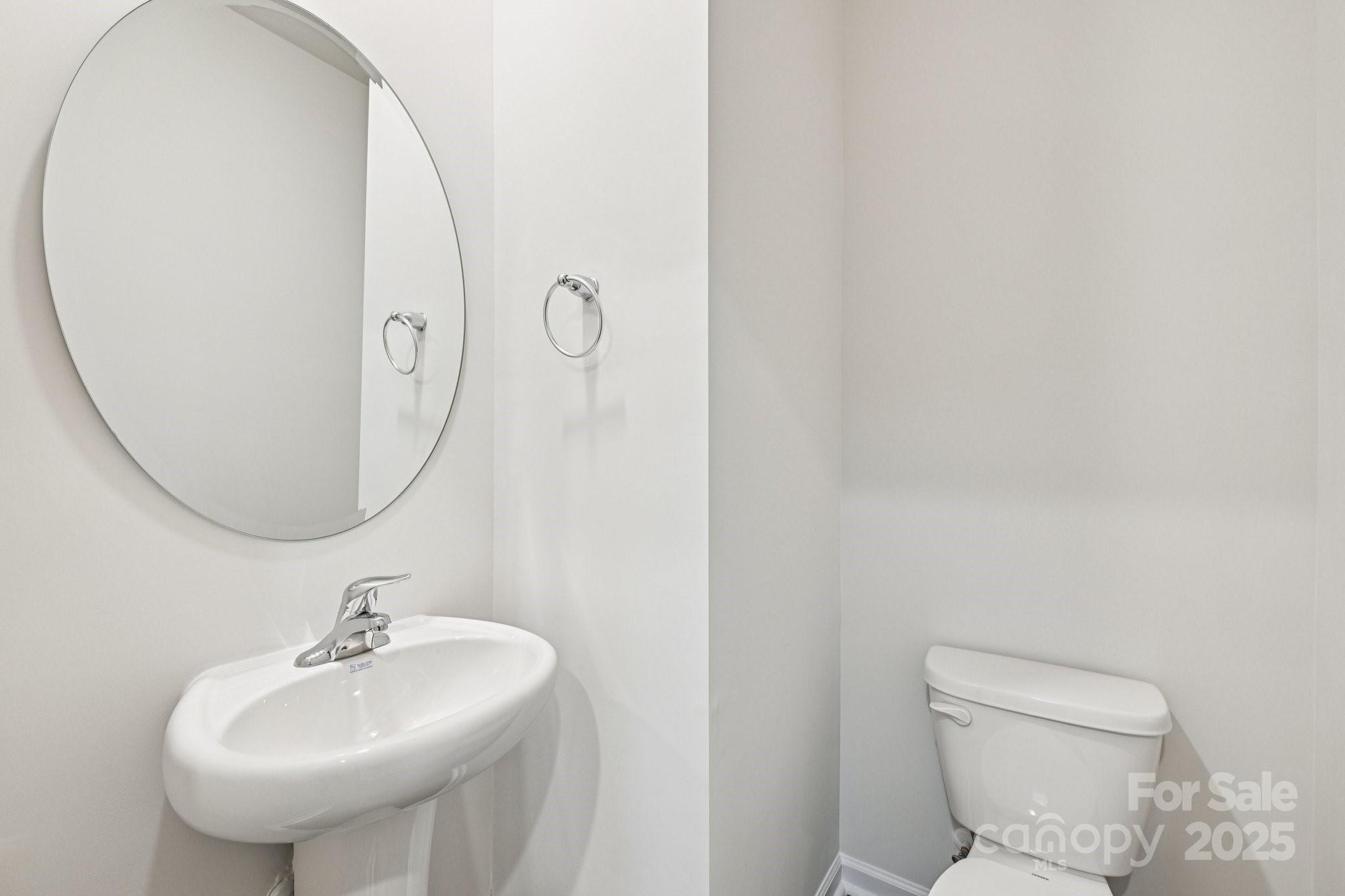 7648 Bainbridge Road Sherrills Ford, NC 28673 - Photo 11 of 25 a bathroom with a sink a mirror and a toilet
