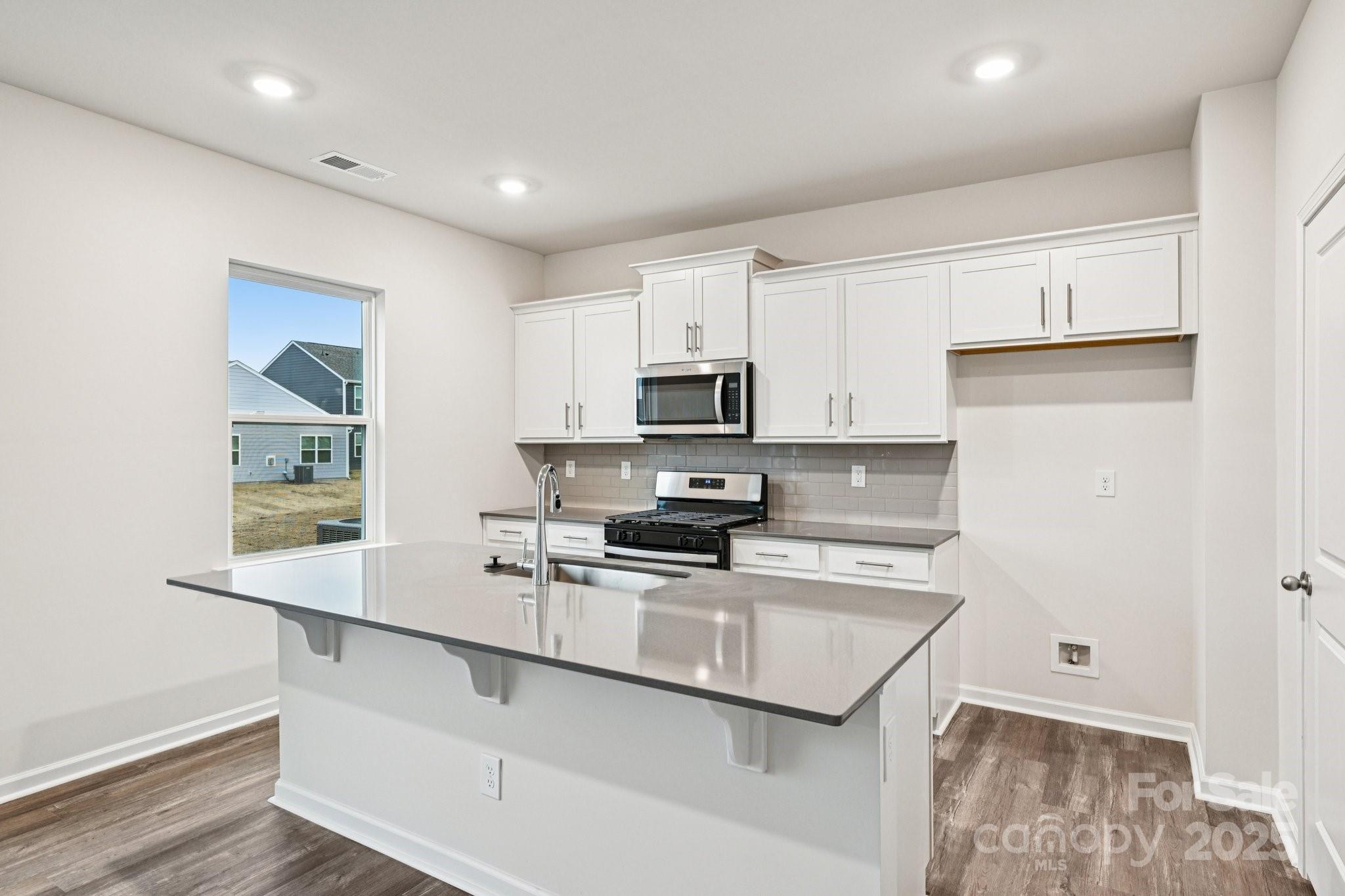 7648 Bainbridge Road Sherrills Ford, NC 28673 - Photo 7 of 25 a kitchen with stainless steel appliances granite countertop a sink stove and microwave
