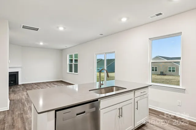 a kitchen with sink and mirror