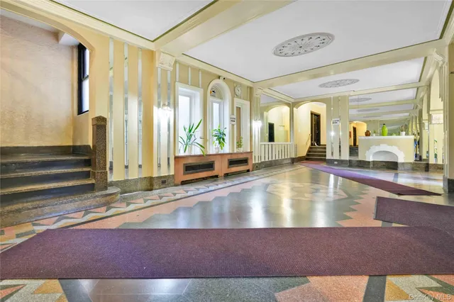 a living room with furniture a flat screen tv and a ceiling fan