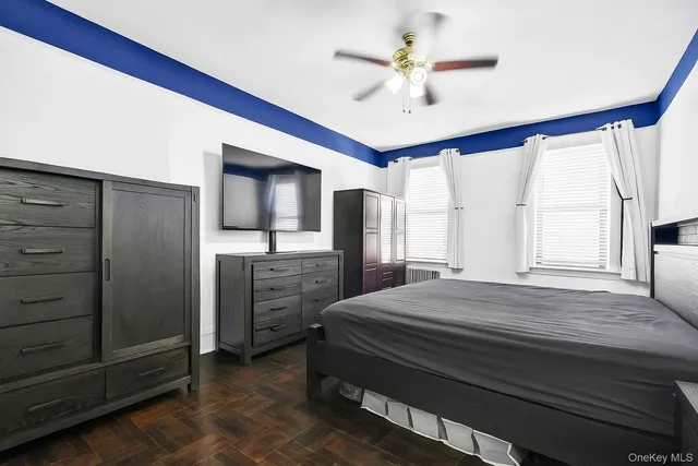 a bedroom with a bed and a ceiling fan