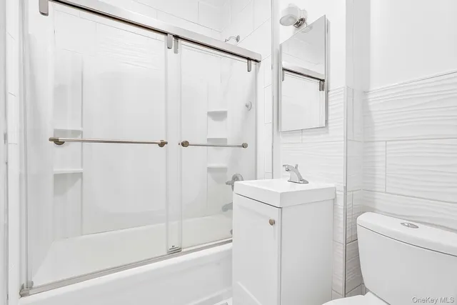 a utility room with refrigerator and washer
