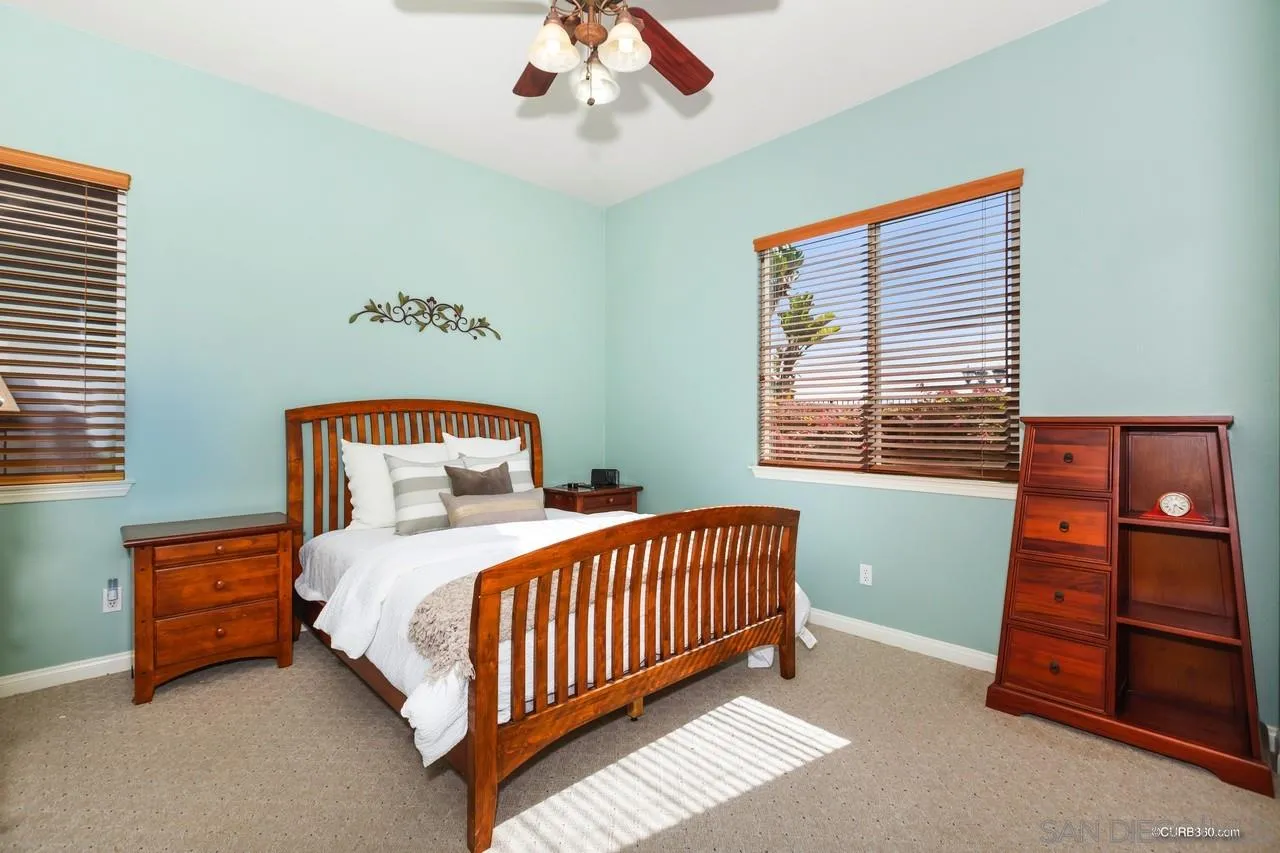 16290 Deer Ridge Road San Diego, CA 92127 - Photo 28 of 36 a bedroom with a bed and a window