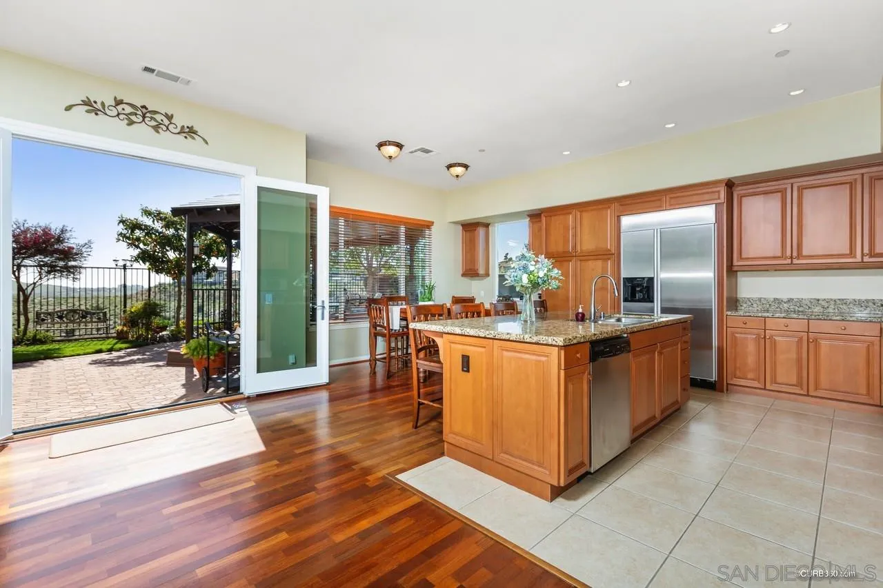16290 Deer Ridge Road San Diego, CA 92127 - Photo 3 of 36 a kitchen with counter top space and wooden floor
