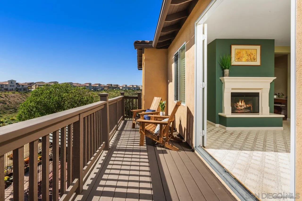 16290 Deer Ridge Road San Diego, CA 92127 - Photo 8 of 36 a balcony with wooden floor table and chair