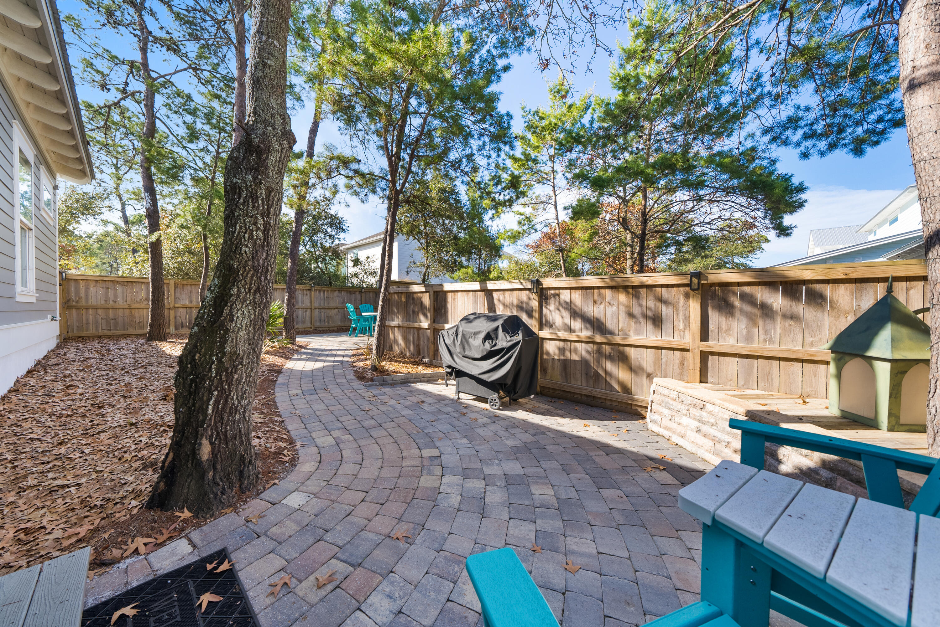 173 West Willow Mist Road Inlet Beach, FL 32461 - Photo 30 of 51 a view of a patio with table and chairs with wooden fence and plants