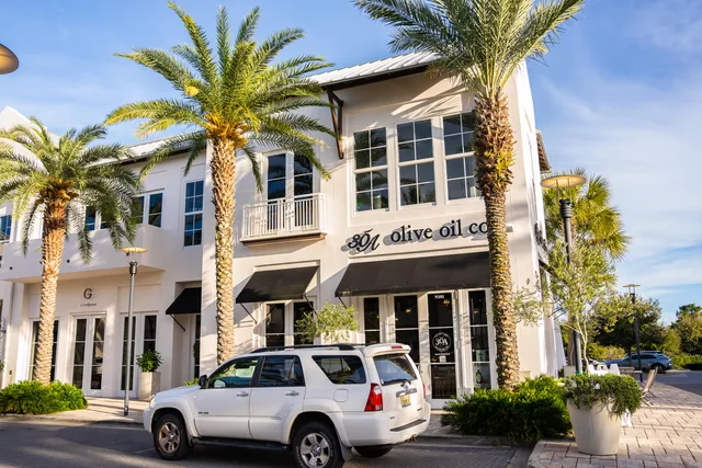 a view of multiple houses with a yard and furniture