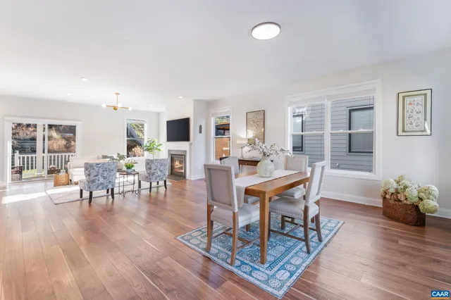 a kitchen with a counter top space a sink appliances and a living room view
