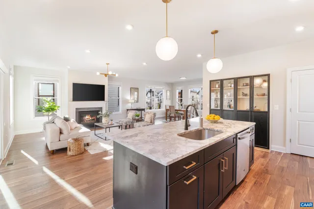 a balcony with couple of chairs and wooden floor