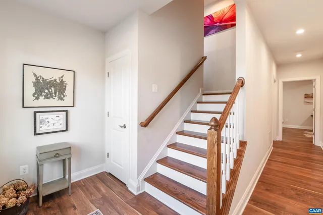 a bedroom with a bed and a flat tv screen on dresser