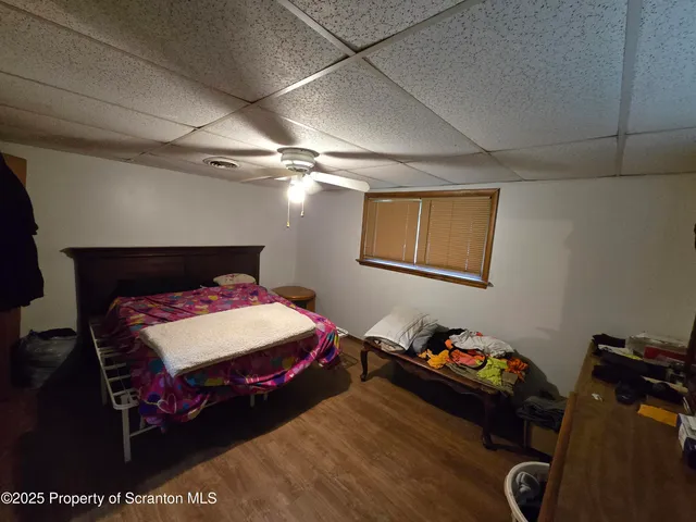 a bedroom with bed and a chandelier