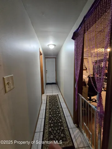 a view of hallway with wooden floor