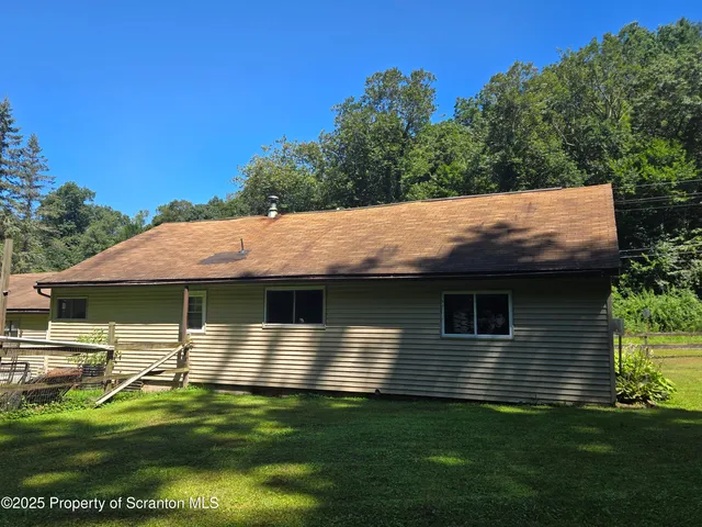 a backyard of a house with yard table and chairs