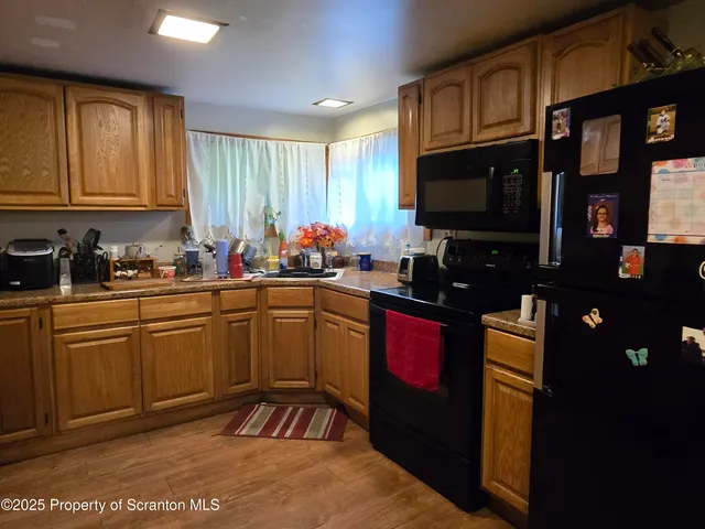 a kitchen with stainless steel appliances granite countertop a stove refrigerator sink and cabinets
