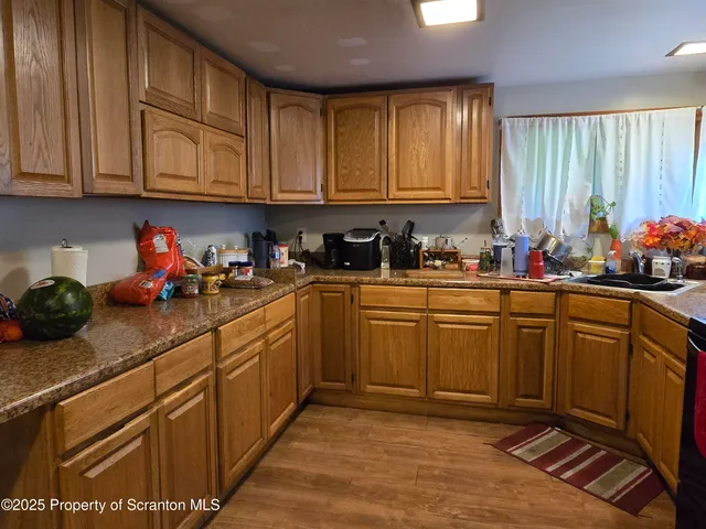 a kitchen with stainless steel appliances granite countertop a sink dishwasher stove and cabinets