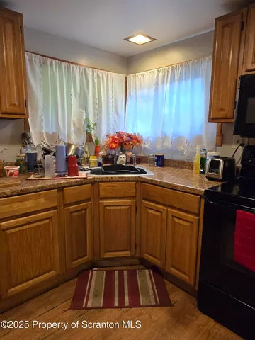 a kitchen with stainless steel appliances a sink stove and cabinets