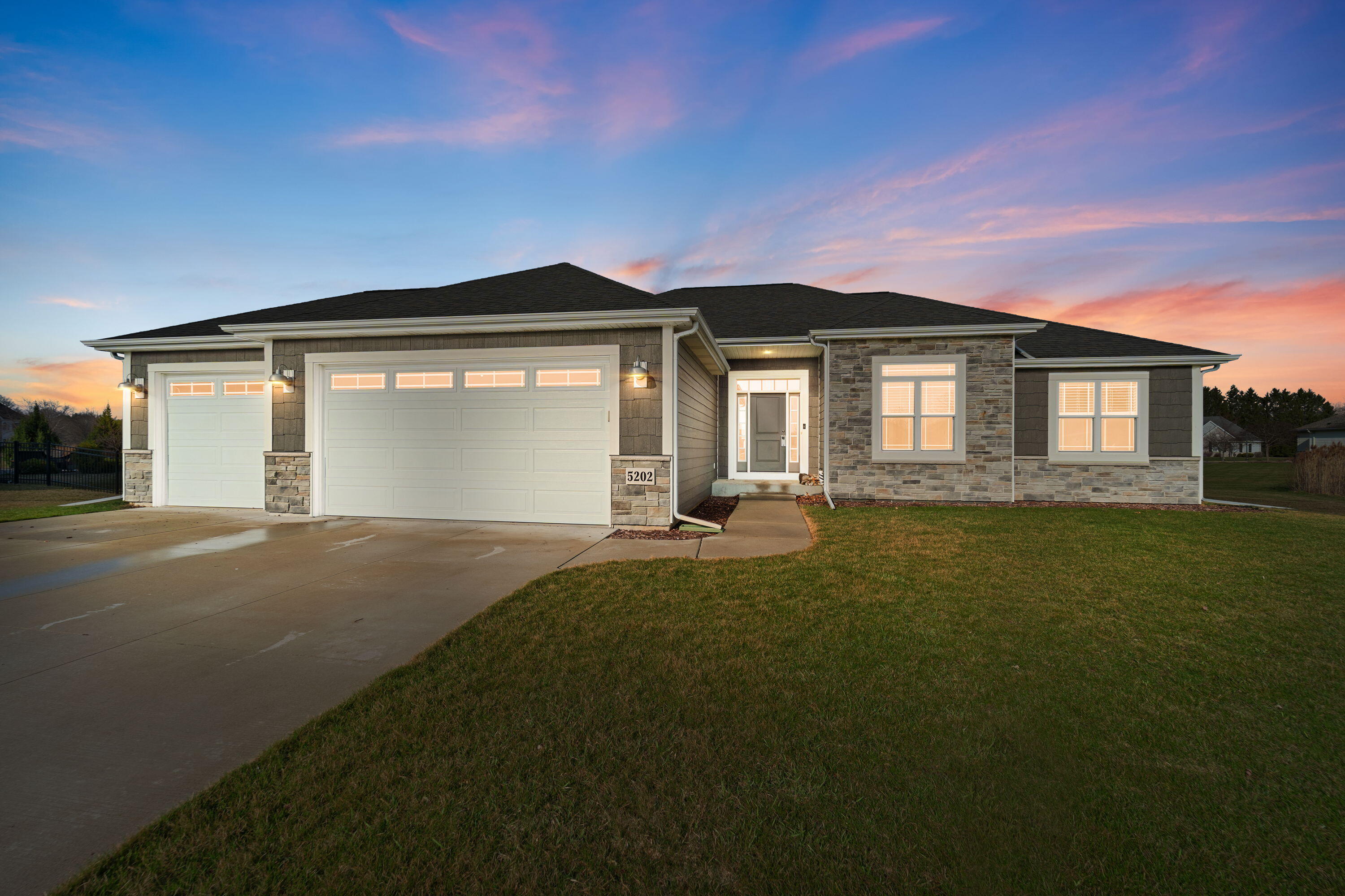 Beautiful newer construction with stone accents and welcoming front entry
