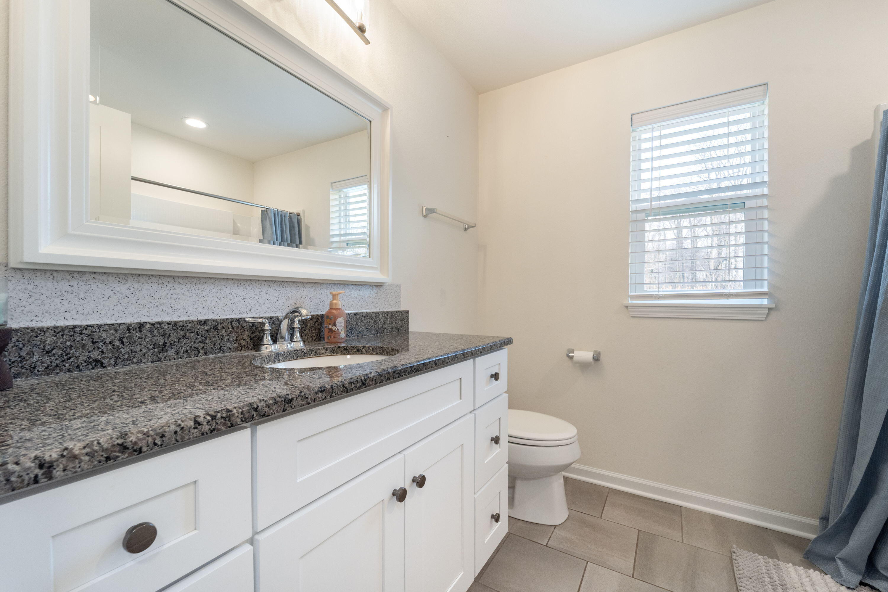 5202 Cornerstone Way Mount Pleasant, WI 53403 - Photo 10 of 29 Updated vanity with stone top and tiled flooring