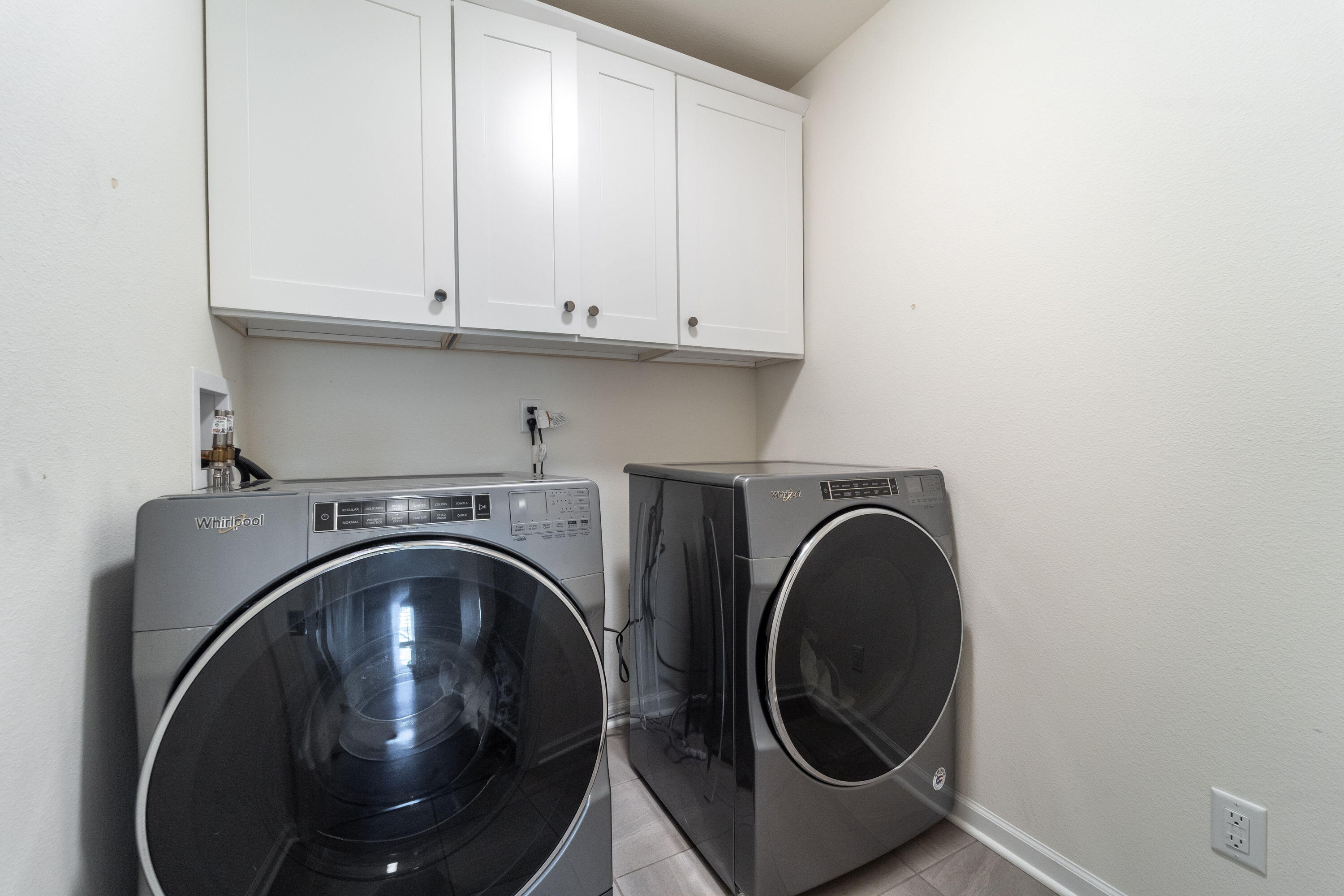5202 Cornerstone Way Mount Pleasant, WI 53403 - Photo 12 of 29 Convenient main floor laundry with storage cabinets