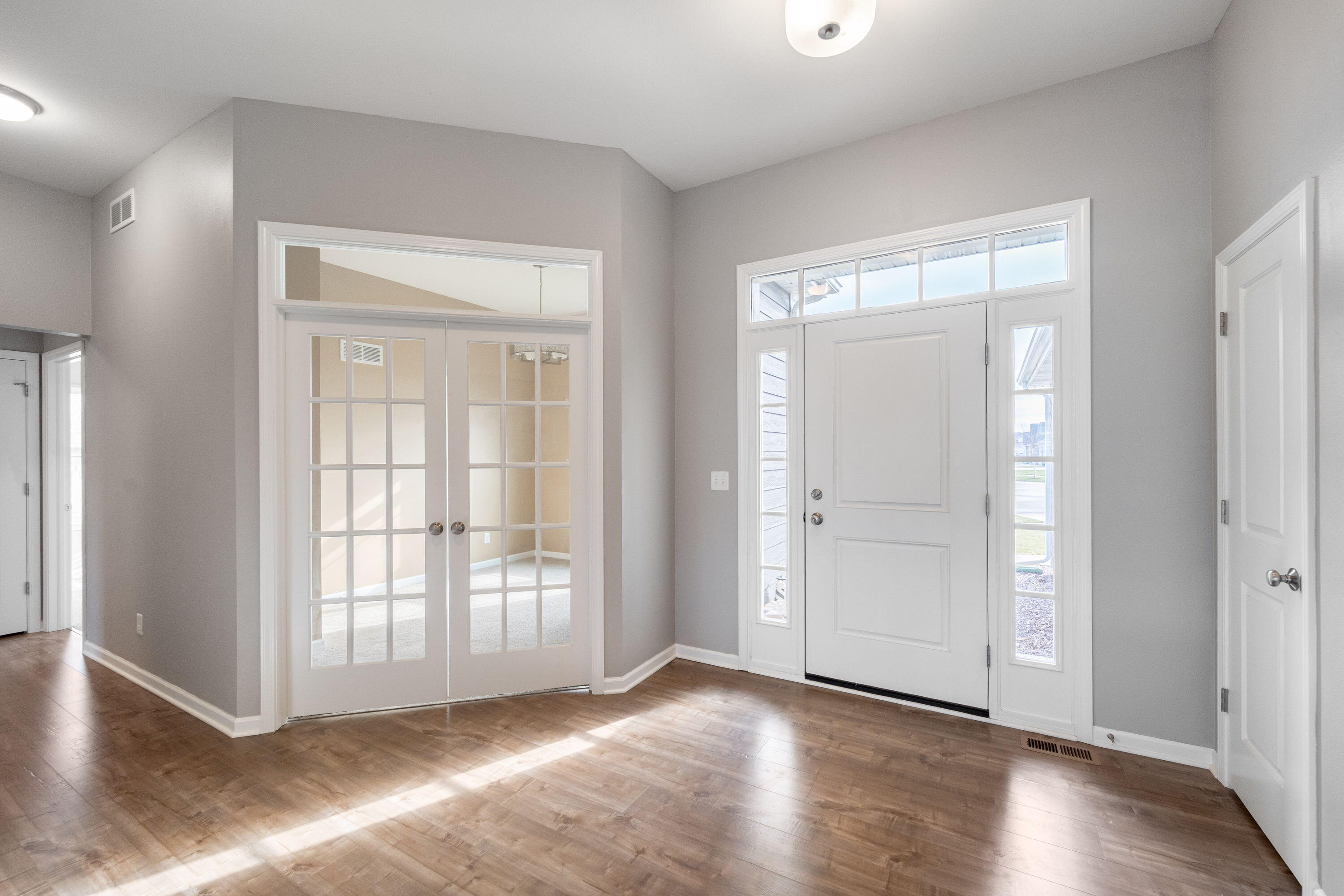 5202 Cornerstone Way Mount Pleasant, WI 53403 - Photo 16 of 29 Welcoming foyer with natural light and private office with French doors