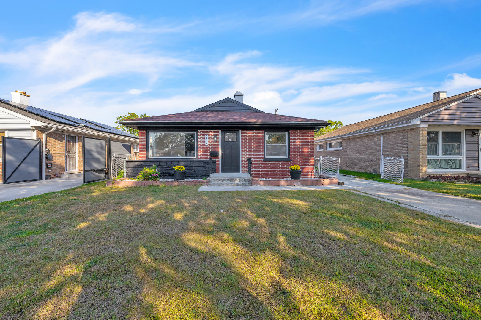 a front view of a house with a garden